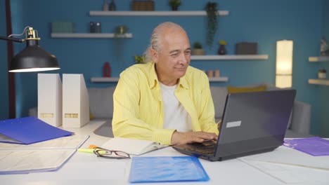 Home-office-worker-old-man-happy-and-smiling.